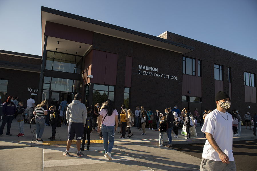 Parents and students mask up as they gather for the first day of classes at Marrion Elementary School on Aug. 31.