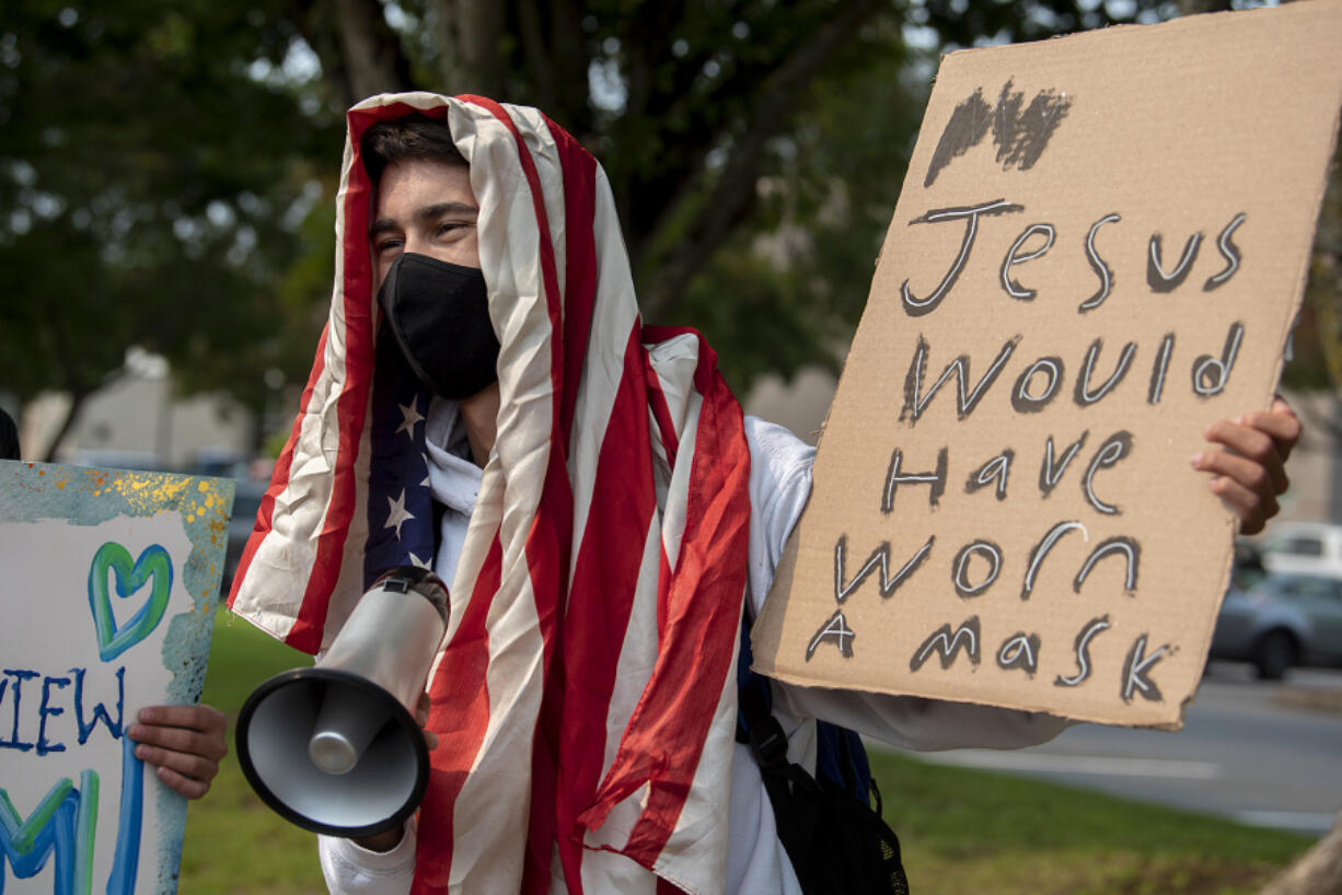 Skyview High School senior Dylan Walker, 18, shows his support Tuesday afternoon for masks in school during a demonstration with classmates and others. Walker came out to oppose anti-mask protesters last week, too.