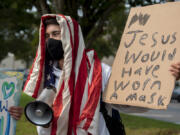 Skyview High School senior Dylan Walker, 18, shows his support Tuesday afternoon for masks in school during a demonstration with classmates and others. Walker came out to oppose anti-mask protesters last week, too.