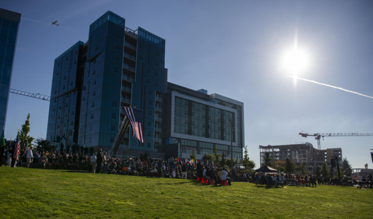 A plane flies overhead as hundreds gather for the 9/11 Remembrance Ceremony on Saturday at Waterfront Park in downtown Vancouver, marking 20 years since the terrorist attacks that hit the Pentagon and the Twin Towers of the World Trade Center.