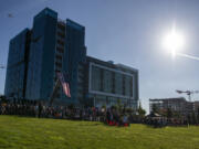 A plane flies overhead as hundreds gather for the 9/11 Remembrance Ceremony on Saturday at Waterfront Park in downtown Vancouver, marking 20 years since the terrorist attacks that hit the Pentagon and the Twin Towers of the World Trade Center.