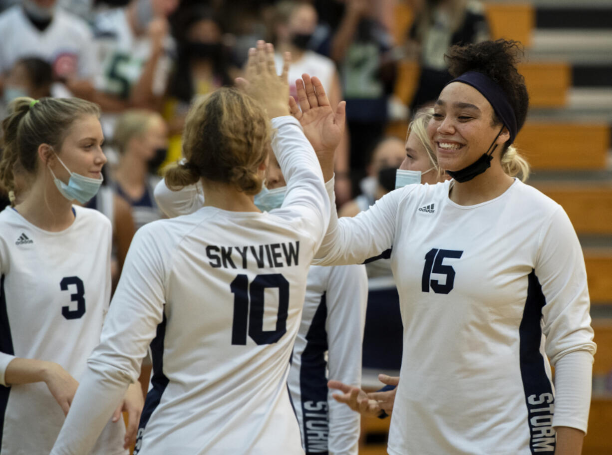 Skyview senior Tyra Schaub, No. 15, gives teammate Lauren harris a high five before  a 4A/3A Greater St. Helens League match on Tuesday, Sept. 14, 2021, at Skyview High School.