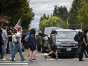 Skyview High School students pass dueling protests outside their school Friday afternoon. Opposing groups expressed different points of view on the Vancouver Public School's injunction prohibiting protests, rallies or other demonstrations that "disrupt educational services" within a mile of Vancouver schools.