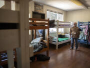 Adam Kravitz of Outsiders Inn inspects a dorm room at the St. Paul Lutheran Church in downtown Vancouver, where the nonprofit provides its services.