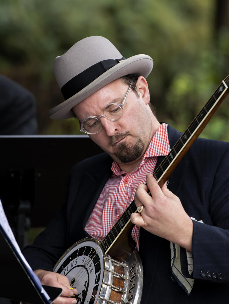 A member of Ne Plus Ultra Jazz Orchestra plays the banjo at the Arts Alive! event on Saturday, Sept. 18, 2021, at the Public Service Center Plaza in downtown Vancouver.