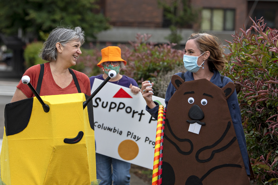 Columbia Play Project performers Jeanne Bennett, from left, Mary Sisson and Maureen Montague make their way through downtown Vancouver during a fundraiser for Give More 24! on Thursday morning. The nonprofit is working to build a children's museum in Vancouver.