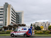 An ambulance passes PeaceHealth Southwest Medical Center on in September 2021.