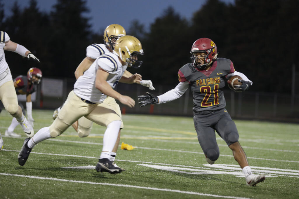 Prairie's Alex Ford gains yards against the Kelso Hilanders at District Stadium in Battle Ground on Friday, September 24, 2021.