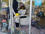 A window is smashed at Vancouver boutique LiquidNation Liquidators. Owner Jullienne Adams arrived at her store Wednesday morning to find the glass shattered and $3,000 worth of merchandise stolen.