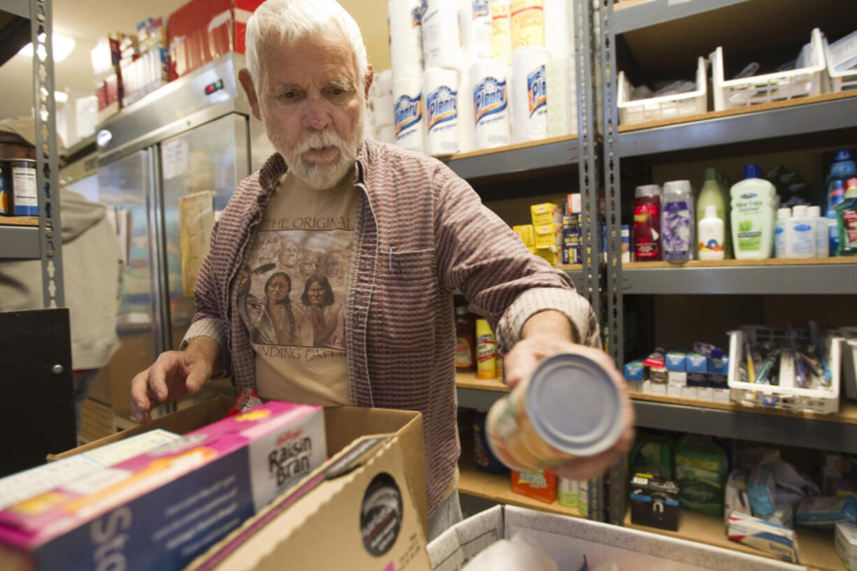 Jerry West fills an order at Martha's Pantry, the area's only food bank aimed specifically at people with HIV/AIDS on Oct. 24, 2013. West, who was instrumental in the charity's founding, died Tuesday at age 84 after battling an infection.