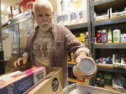 Jerry West fills an order at Martha's Pantry, the area's only food bank aimed specifically at people with HIV/AIDS on Oct. 24, 2013. West, who was instrumental in the charity's founding, died Tuesday at age 84 after battling an infection.