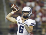 Utah State quarterback Andrew Peasley throws a pass during the first half of the team's NCAA college football game against Washington State, Saturday, Sept. 4, 2021, in Pullman, Wash.