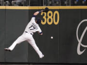 Seattle Mariners right fielder Mitch Haniger can't catch a deep fly ball that fell in for a triple by Boston Red Sox's Xander Bogaerts during the eighth inning of a baseball game Tuesday, Sept. 14, 2021, in Seattle.