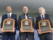 Hall of Fame inductees, from left, Derek Jeter, Larry Walker and Ted Simmons hold their plaques for photos after the induction ceremony at Clark Sports Center on Wednesday, Sept. 8, 2021, at the National Baseball Hall of Fame in Cooperstown, N.Y.