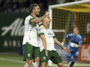 Portland Timbers forward Felipe Mora, front right, celebrates his second-half goal against the Colorado Rapids during an MLS soccer match Wednesday, Sept. 15, 2021, in Portland, Ore.