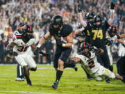 Purdue running back Zander Horvath (40) runs past Oregon State linebacker Andrzej Hughes-Murray (2) for a touchdown during the first half of an NCAA college football game in West Lafayette, Ind., Saturday, Sept. 4, 2021.