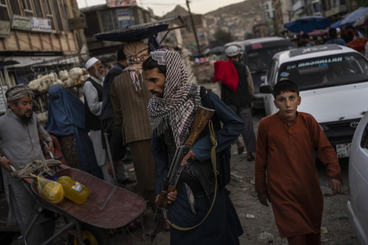 Taliban fighters patrol a market in Kabul's Old City, Afghanistan, Tuesday, Sept. 14, 2021. A month after the fall of Kabul, the question of how the world will get aid to citizens without enriching Afghanistan's Taliban rulers is haunting the country. The stakes have soared for Afghans, who along with the threat of famine and a collapsing health care system face a looming crisis as winter approaches.