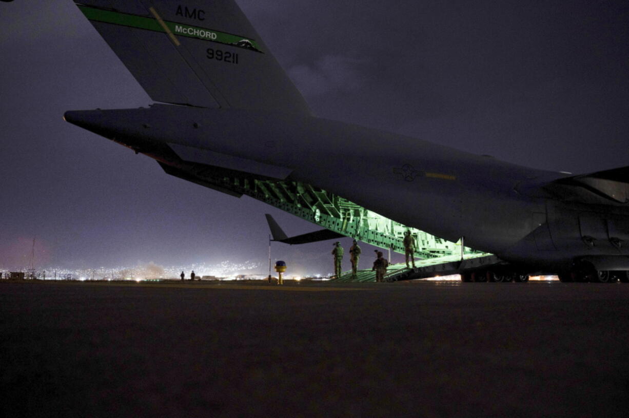 FILE - In this Aug. 30, 2021 photo provided by the U.S. Air Force, an Air Force aircrew, assigned to the 816th Expeditionary Airlift Squadron, prepares to receive soldiers, assigned to the 82nd Airborne Division, to board a U.S. Air Force C-17 Globemaster III aircraft in support of the final noncombatant evacuation operation missions at Hamid Karzai International Airport in Kabul Afghanistan. The Taliban, which is in need of foreign aid, has said it will allow people with valid travel papers to leave, and the international community says it will be monitoring to see if they keep their word. (Senior Airman Taylor Crul/U.S.