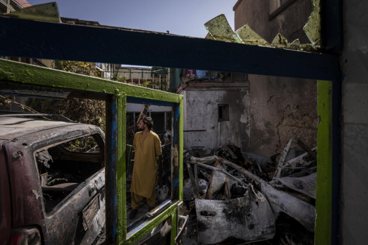 An Afghan inspects the damage of Ahmadi family house in Kabul, Afghanistan, Monday, Sept. 13, 2021. Zemerai Ahmadi, the Afghan man who was killed in a U.S. drone strike last month was an enthusiastic and beloved longtime employee at an American humanitarian organization, his colleagues say, painting a stark contrast to the Pentagon's claims that he was an Islamic State group militant about to carry out an attack on American troops.