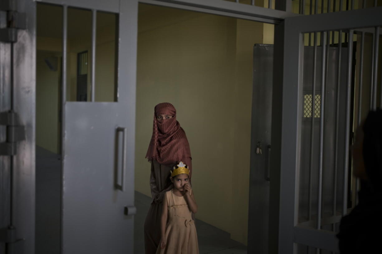 Razia and her 6-year-old daughter Alia, stand inside the women's section of the Pul-e-Charkhi prison in Kabul, Afghanistan, Thursday, Sept. 23, 2021. When the Taliban took control of a northern Afghan city of Pul-e-Kumri the operator of the only women's shelter ran away, abandoning 20 women in it. When the Taliban arrived at the shelter the women were given two choices: Return to their abusive families, or go with the Taliban, With nowhere to put the women, the Taliban took them to the abandoned women's section of Afghanistan's notorious Pul-e-Charkhi prison.