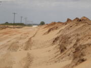 Sand that blew off farmers' fields is piled up in a ditch outside Lingo, N.M., near the Texas-New Mexico border on Tuesday, May 18, 2021. The U.S. Department of Agriculture is encouraging farmers in a "Dust Bowl zone" that includes parts of Texas, New Mexico, Oklahoma, Kansas and Colorado to establish and preserve grasslands to prevent wind erosion as the area becomes increasingly dry.