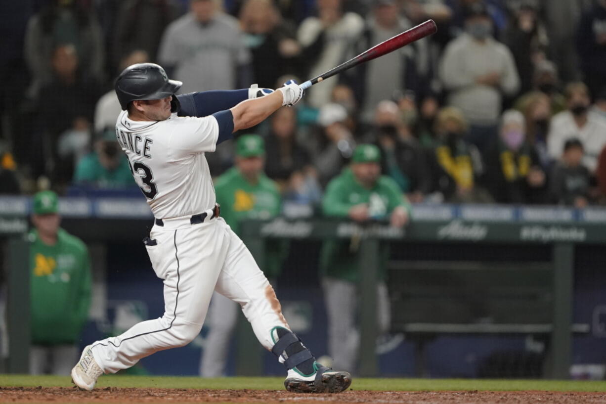 Seattle Mariners' Ty France hits a sacrifice fly to score Dylan Moore during the seventh inning of a baseball game against the Oakland Athletics, Wednesday, Sept. 29, 2021, in Seattle. (AP Photo/Ted S.