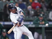 A "Believe" sign, similar to one seen in the TV series "Ted Lasso," hangs from outfield seats as fans look on during a baseball game between the Seattle Mariners and Oakland Athletics Monday, Sept. 27, 2021, in Seattle.