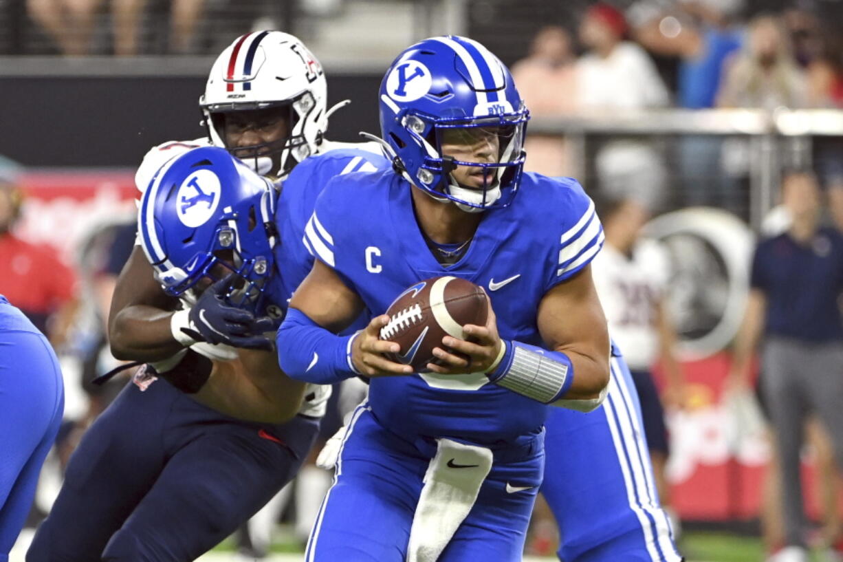 BYU quarterback Jaren Hall looks to hand off the ball against Arizona during the second half of an NCAA college football game Saturday, Sept. 4, 2021, in Las Vegas.