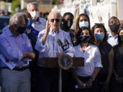 President Joe Biden speaks as he tours a neighborhood impacted by flooding from the remnants of Hurricane Ida, Tuesday, Sept. 7, 2021, in the Queens borough of New York.