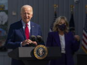 President Joe Biden, with first lady Jill Biden, speaks during a visit at Brookland Middle School in northeast Washington, Friday, Sept. 10, 2021. Biden has encouraged every school district to promote vaccines, including with on-site clinics, to protect students as they return to school amid a resurgence of the coronavirus.