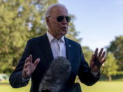 President Joe Biden stops to speak to members of the media as he arrives at the White House in Washington, Sunday, Sept. 26, 2021, after returning from a weekend at Camp David.