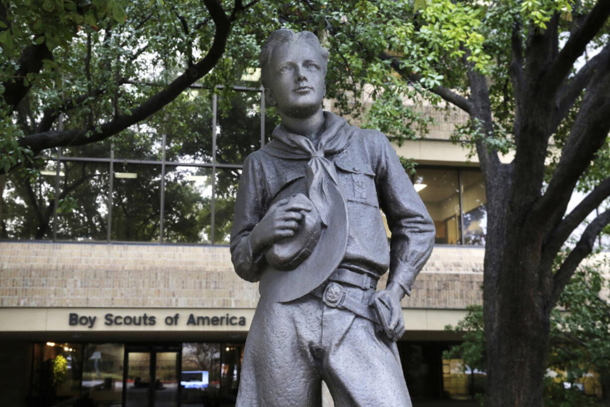 FILE - In this Feb. 12, 2020, file photo, a statue stands outside the Boy Scouts of America headquarters in Irving, Texas. One of the primary insurers of the Boy Scouts of America announced Tuesday, Sept. 14, 2021, that it has reached a tentative settlement agreement with the organization and with attorneys representing tens of thousands of men who say they were molested as youngsters decades ago by scoutmasters and others.