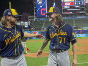 Milwaukee Brewers starter Corbin Burnes, left, and reliever Josh Hader celebrate after pitching a combined no-hitter against the Cleveland Indians in a baseball game in Cleveland, Saturday, Sept. 11, 2021.