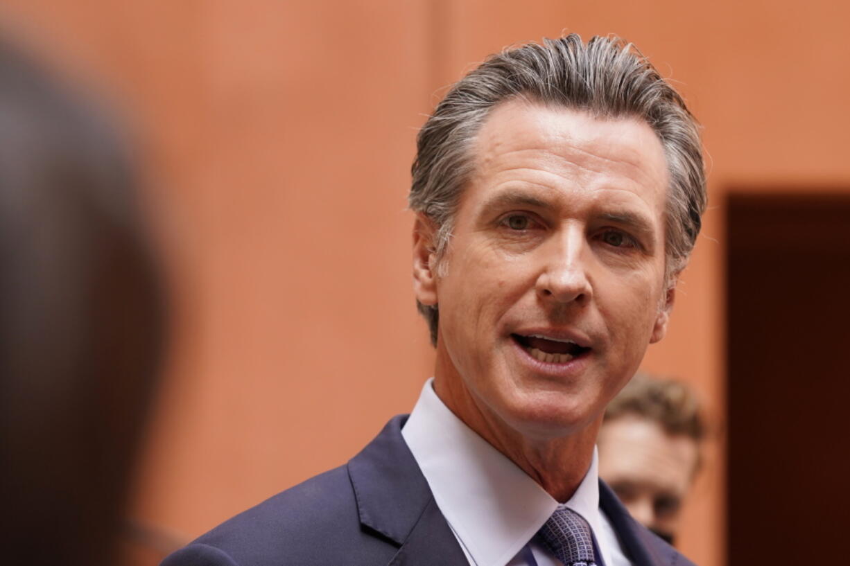 California Gov. Gavin Newsom responds to a question while meeting with reporters after casting his recall ballot at a voting center in Sacramento, Calif., Friday, Sept. 10, 2021. The last day to vote in the recall election is Tuesday Sept. 14. A majority of voters must mark "no" on the recall to keep Newsom in office.