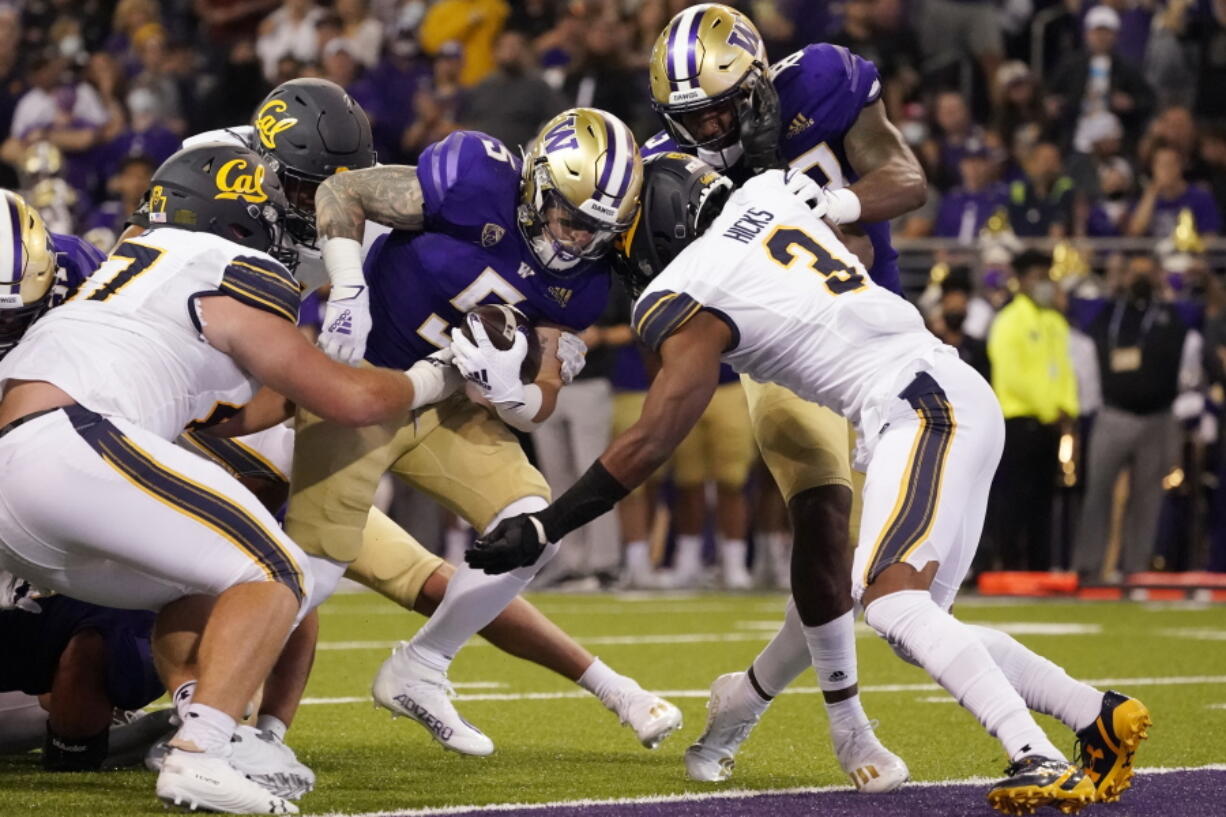 Washington's Sean McGrew (5) scores against California in the second quarter to put the Huskies on top 21-7. Much later, McGrew scored the go-ahead touchdown in overtime as UW won its Pac-12 Conference opener Saturday.