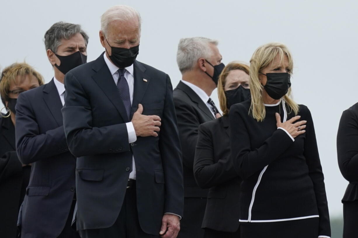 President Joe Biden and first lady Jill Biden watch as a carry team moves the transfer case containing the remains of Navy Corpsman Maxton W. Soviak, 22, of Berlin Heights, Ohio, during a casualty return Sunday, Aug. 29, 2021, at Dover Air Force Base, Del. According to the Department of Defense, Soviak died in an attack at Afghanistan's Kabul airport, along with 12 other U.S. service members.