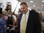 Sen. Jon Tester, D-Mont., stops for reporters asking about the fate of President Joe Biden's $3.5 trillion plan for social and environmental spending, at the Capitol in Washington, Tuesday, Sept. 21, 2021. (AP Photo/J.