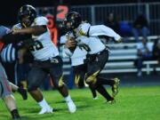 Hudson’s Bay quarterback Dean Castillo pulls the ball down on a run in the third quarter of the Eagles’ 28-12 loss to R.A. Long on Sept. 17 at Longview Memorial Stadium.