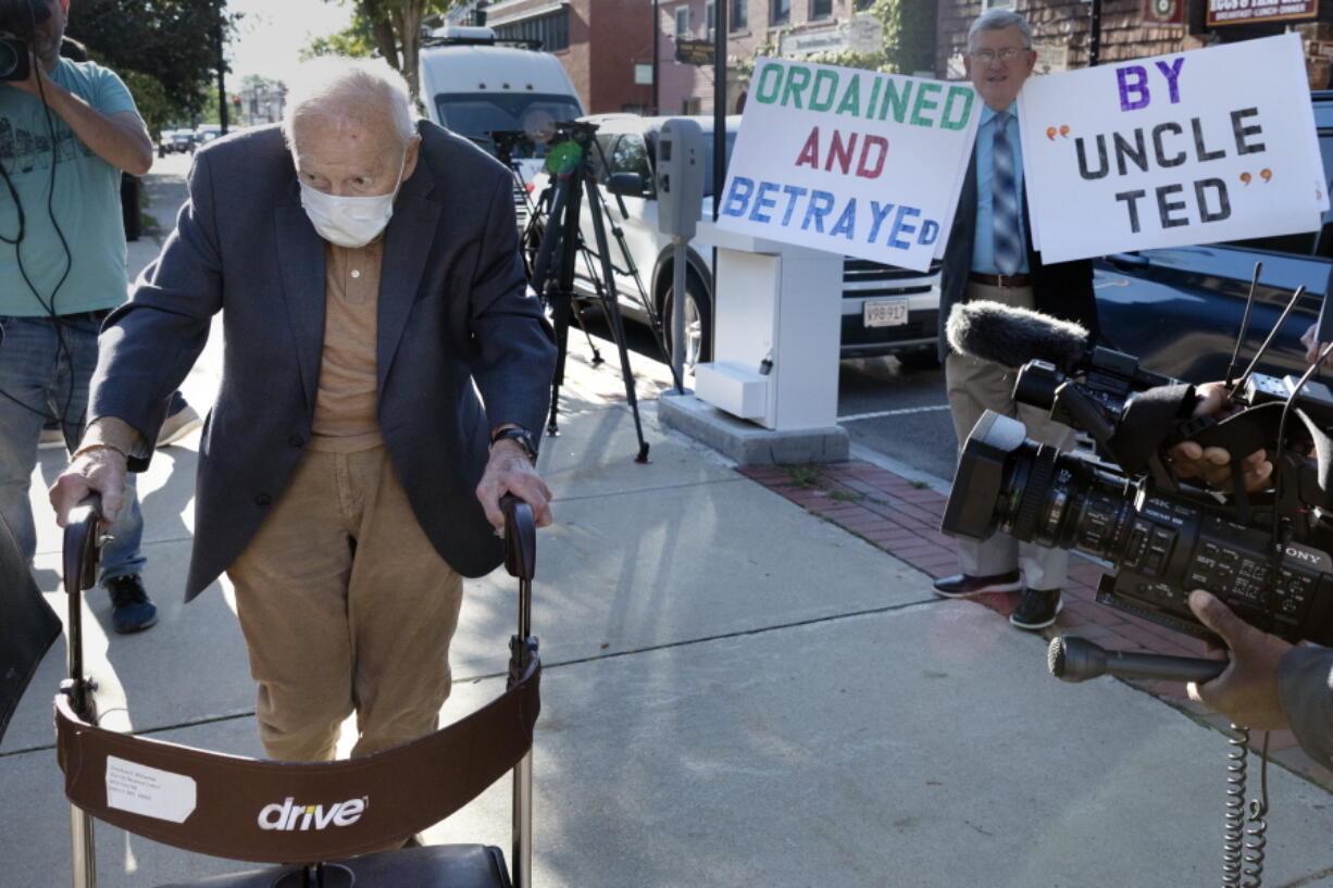 Former Cardinal Theodore McCarrick, left, arrives at Dedham District Court, Friday, Sept. 3, 2021, in Dedham, Mass.  McCarrick, the once-powerful American prelate who was expelled from the priesthood for sexual abuse, pleaded not guilty Friday to sexually assaulting a 16-year-old boy during a wedding reception in Massachusetts nearly 50 years ago.