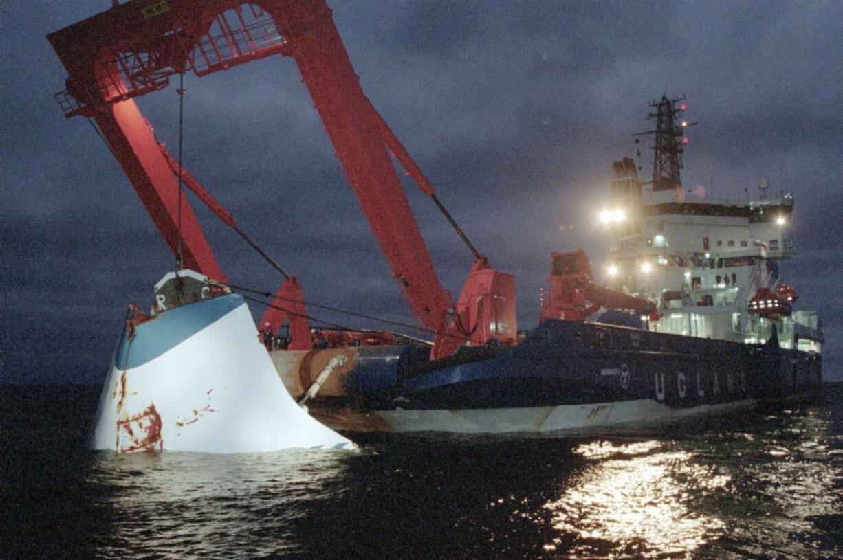 FILE - In this Nov. 19, 1994 file photo, the bow door of the sunken passenger ferry M/S Estonia is lifted up from the bottom of the sea, off Uto Island, in the Baltic Sea, near Finland. A privately-funded expedition, commissioned by relatives of the victims of the M/S Estonia ferry that sank into the Baltic Sea nearly 27 years ago, will dive into the vessel's wreckage this month, Sept. 2021. It's the latest attempt to gain more insight into one of Europe's worst peacetime maritime disasters.