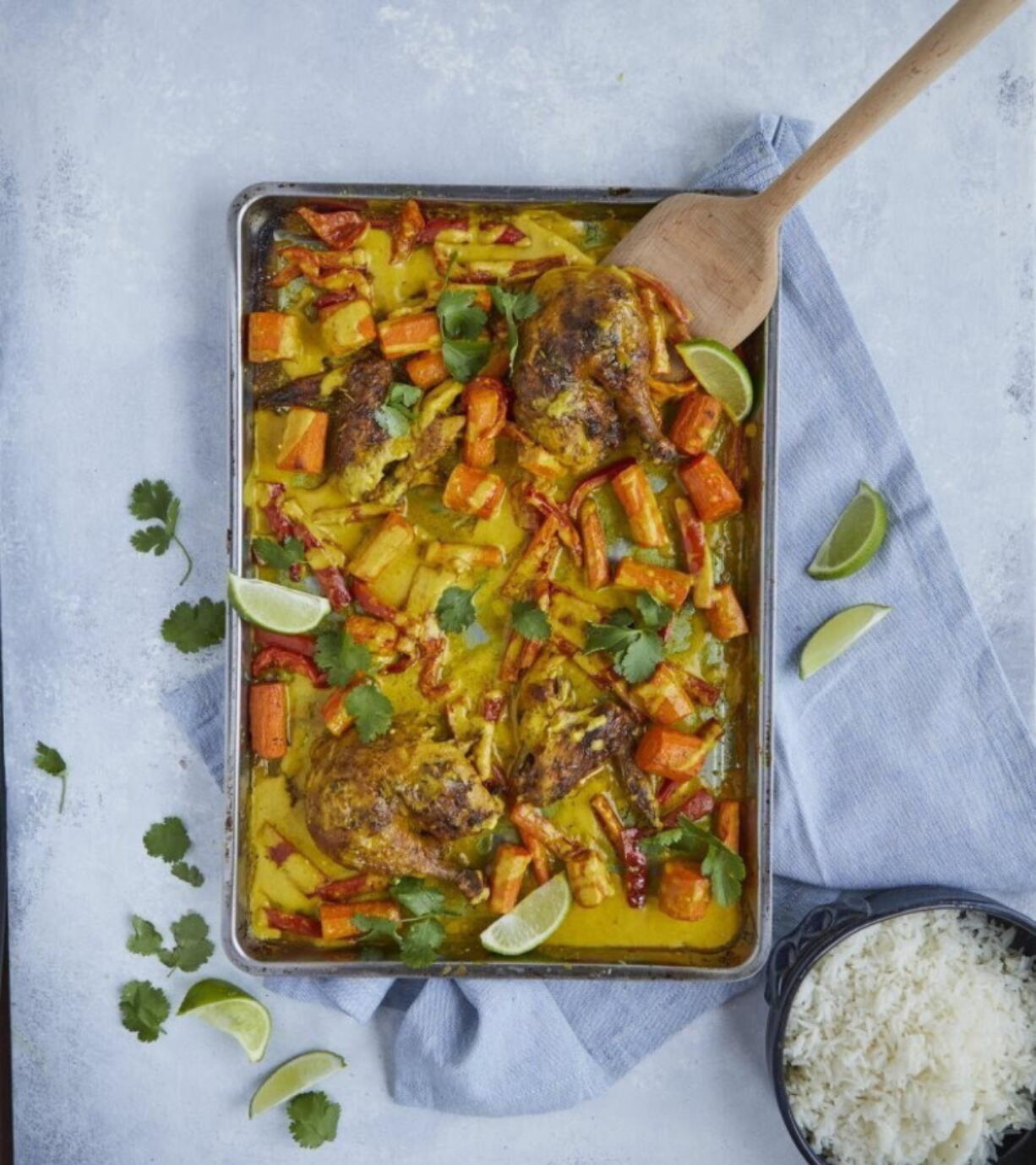 This image released by Simon & Schuster shows a recipe for curried chicken sheet pan dinner from the book "Cook Once Dinner Fix: Quick and Exciting Ways to Transform Tonight's Dinner into Tomorrow's Feast" by Cassy Joy Garcia.