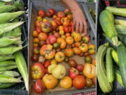 From left, corn, tomatoes and zucchini displayed at a farmers market in Milford, Conn.