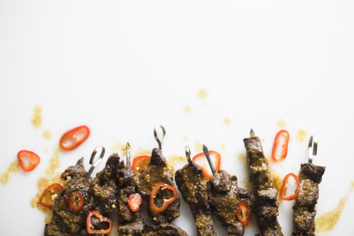 This image released by Milk Street shows a recipe for Curried Beef Skewers.