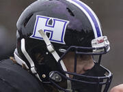 Heritage's Andre Cowley (42) receives the ball from teammate Isaac Washington (23) in the first quarter at McKenzie Stadium on Friday afternoon, March 5, 2021.