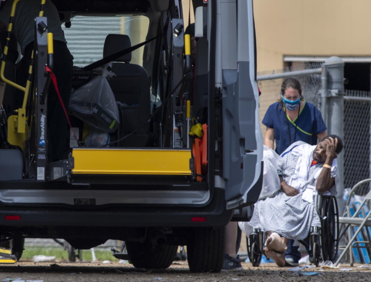 Emergency personnel evacuate people at a mass shelter Thursday, Sept. 2, 2021 in Independence, La. Multiple nursing home residents died after Hurricane Ida, but full details of their deaths are unknown because state health inspectors said Thursday that they were turned away from examining conditions at the facility to which they had been evacuated.