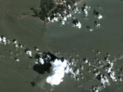 In a satellite image provided by Maxar Technologies, an oil slick is shown on Sept. 2, 2021 south of Port Fourchon, La.  The U.S. Coast Guard said Saturday, Sept. 4,  that cleanup crews are responding to a sizable oil spill in the Gulf of Mexico following Hurricane Ida.