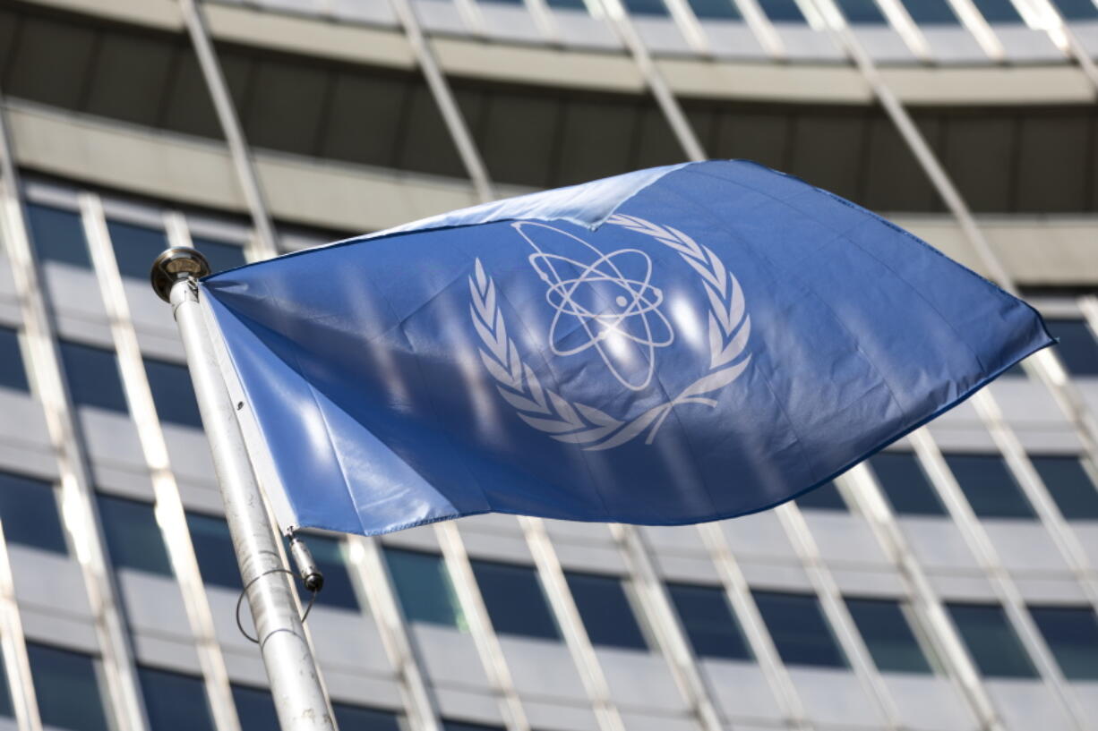 FILE - In this Monday, June 7, 2021 file photo, the flag of the International Atomic Energy Agency (IAEA) waves at the entrance of the Vienna International Center in Vienna. The U.N. atomic watchdog said on Tuesday, Sept. 7 that Iran has continued to increase its stockpile of highly enriched uranium that could be used to make nuclear weapons in contravention of a 2015 accord with world powers that was meant to contain Tehran's nuclear program. The IAEA also told member states in its confidential quarterly report Tuesday that its verification and monitoring activities have been "seriously undermined" since February by Iran's refusal to let inspectors access IAEA monitoring equipment.