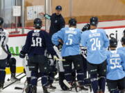 Seattle Kraken head coach Dave Hakstol goes over a drill with players during NHL hockey training camp at Kraken Community Iceplex on Thursday, Sept. 23, 2021, in Seattle.