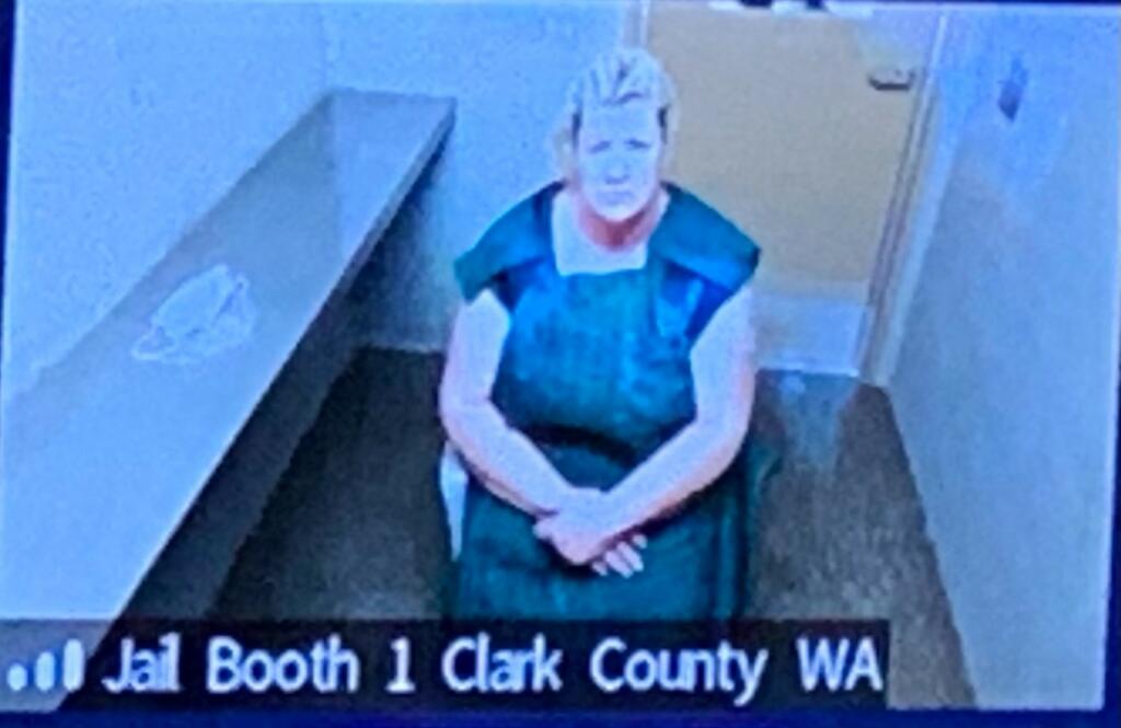 Lani Kraabell, 48, of Winlock makes a first appearance Monday morning, Sept. 13, 2021, in Clark County Superior Court on suspicion of second-degree murder, possession of a stolen firearm and second-degree unlawful possession of a firearm. She is accused of facilitating the sale of stolen firearms linked to an undercover investigation that led to the fatal shooting of Clark County sheriff's Detective Jeremy Brown.