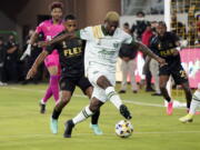 Portland Timbers forward Dairon Asprilla controls the ball in front of a Los Angeles FC defender during the first half of an MLS soccer match Wednesday, Sept. 29, 2021, in Los Angeles.